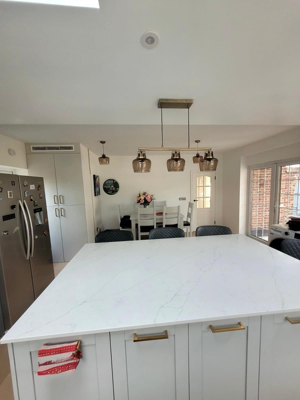 Modern kitchen with white quartz island after decorating