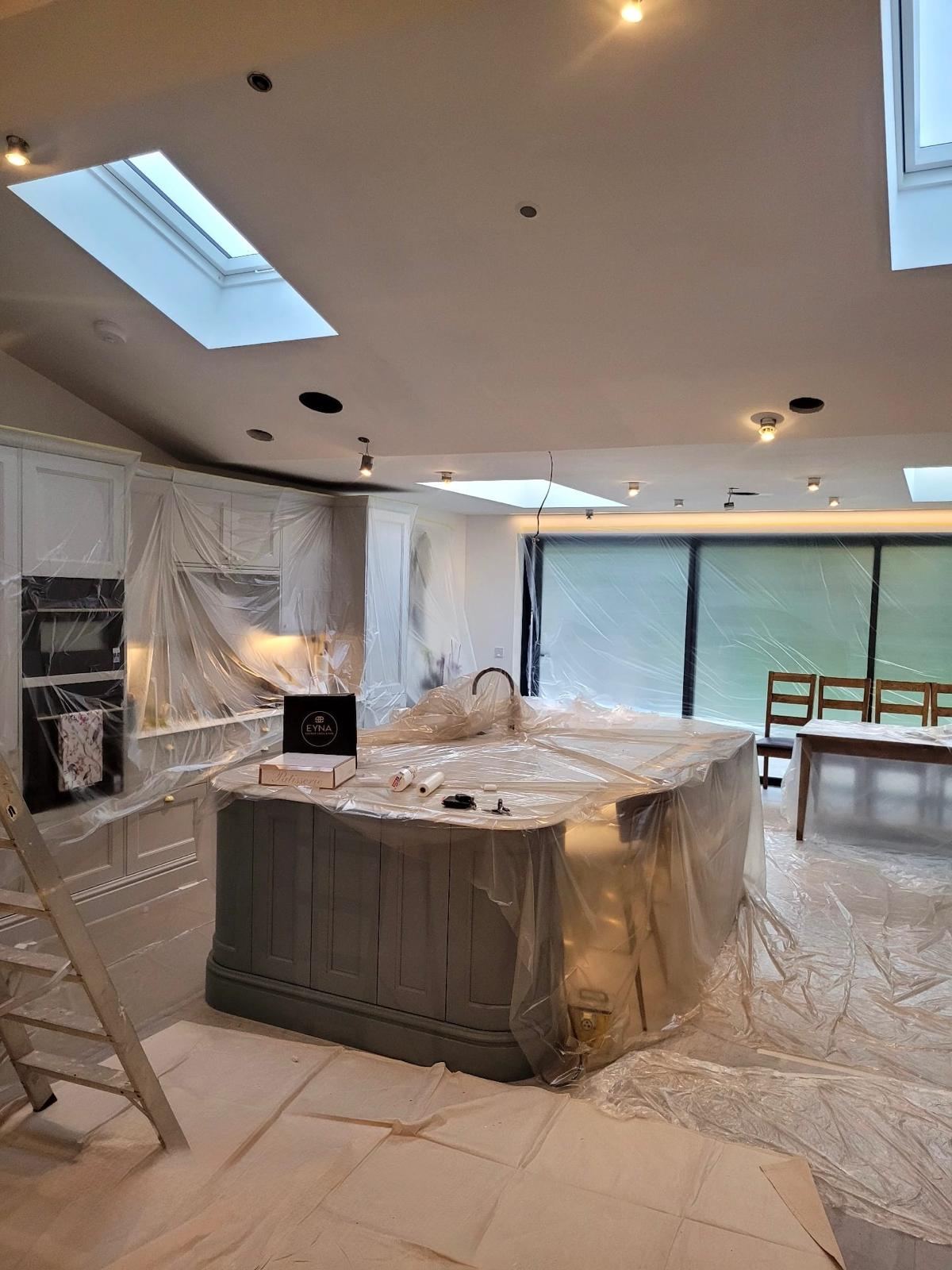 Kitchen fully masked and protected with dust sheets before spraying begins